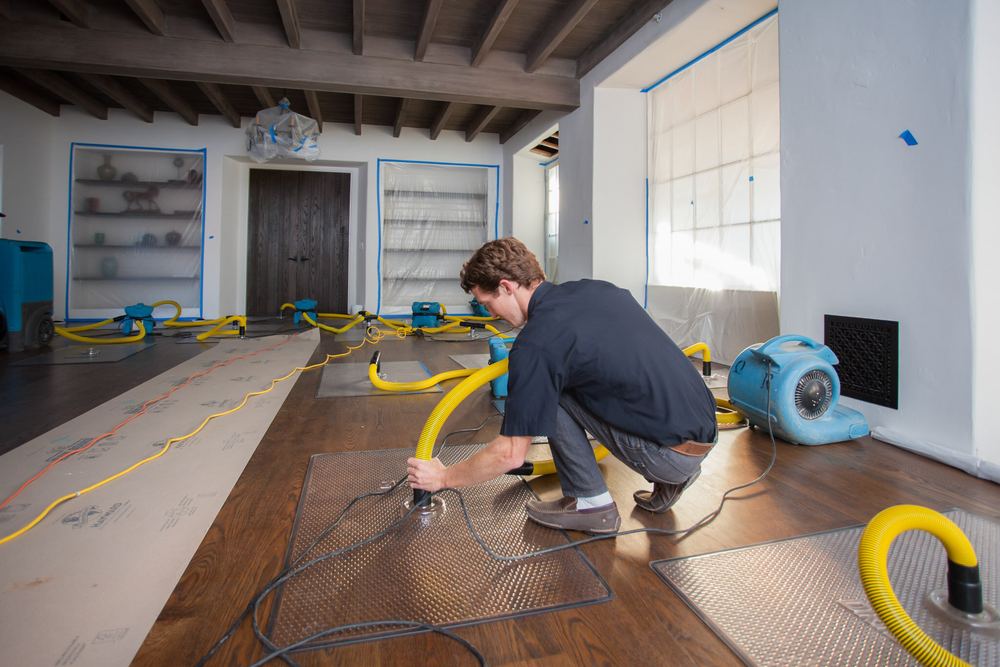 Standing water being cleaned from a flooded interior floor